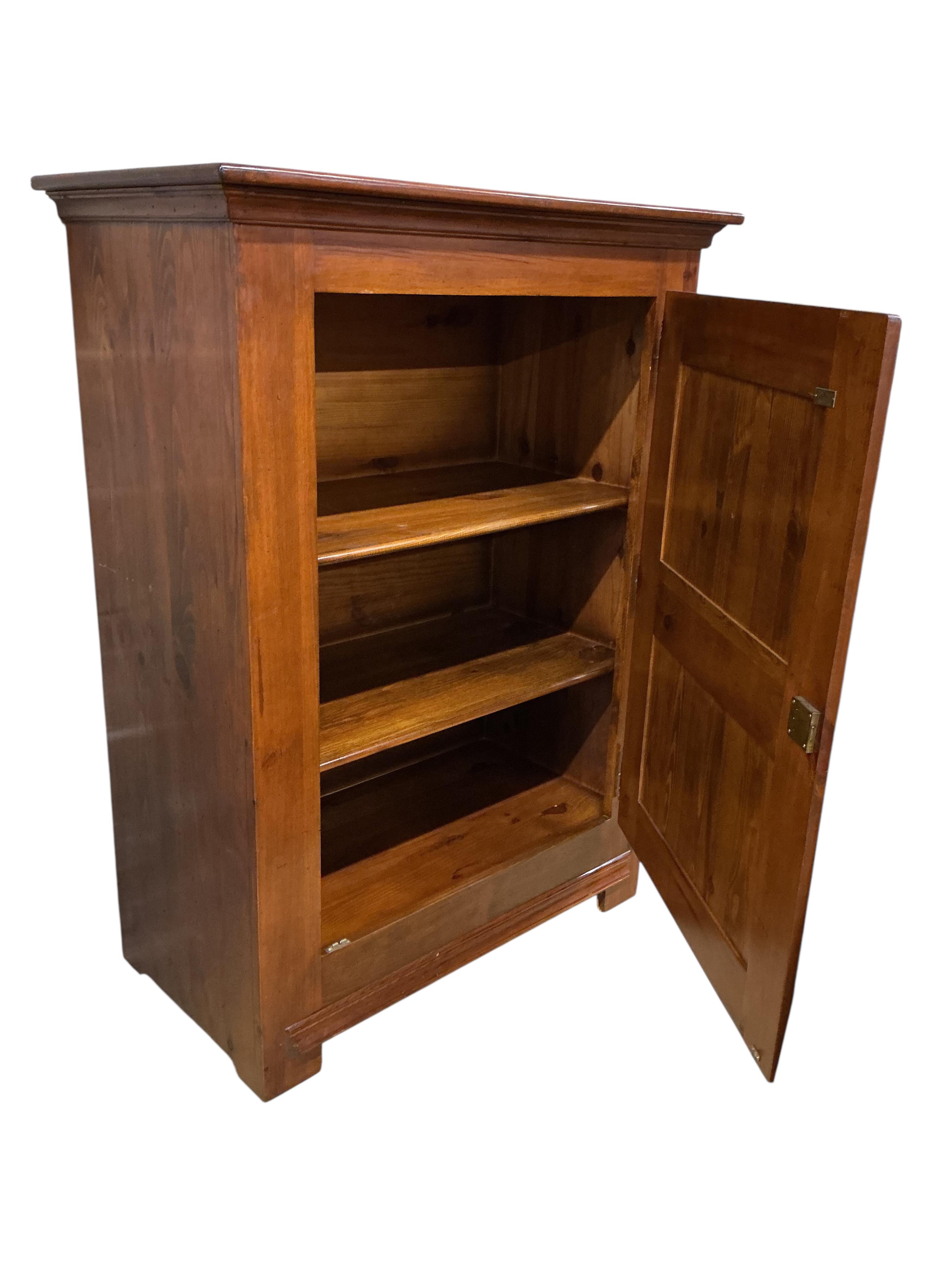 A reproduction 18th century style French pine side cabinet, width 104cm, depth 55cm, height 140cm